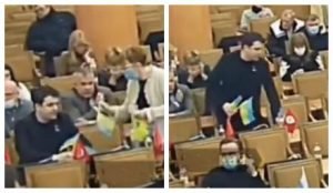 Депутат "Партии Шария" собрал и выкинул в сторону флаги Украины