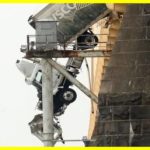 Driver rescued from truck hanging on bridge