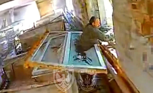 Russian Soldier Gets Stuck in Window Escaping Ukrainian Drone