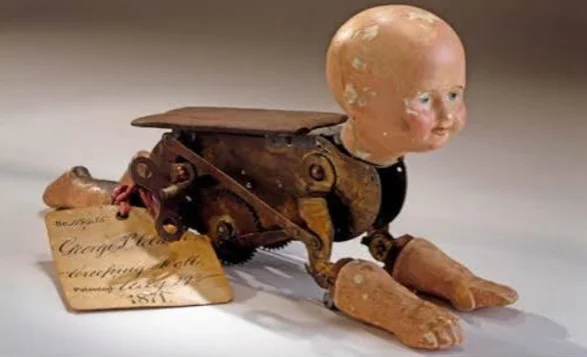 The story behind a 150-year-old mechanical doll that crawls like a real baby